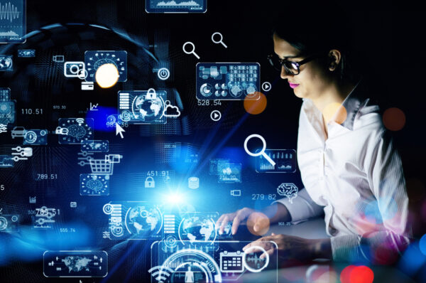 Young woman working in the night office. System engineering. Digital transformation.